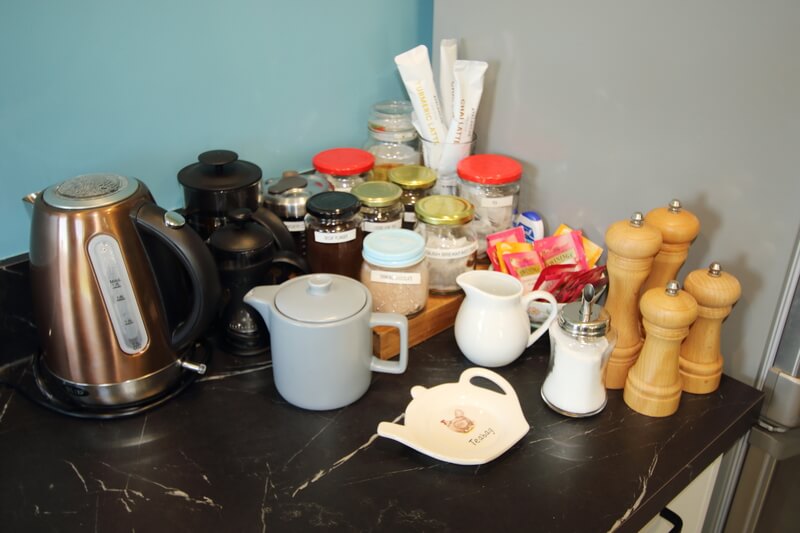 A kettle, coffees, teas and jams.